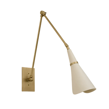 A modern wall-mounted arm lamp with a brass-finished adjustable arm and rectangular wall plate, paired with a tapered off-white shade accented by a thin brass band, shown against a solid light gray background.