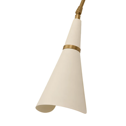 A modern pendant light fixture with a tapered off-white cone shade and polished brass hardware, shown against a solid light gray background.